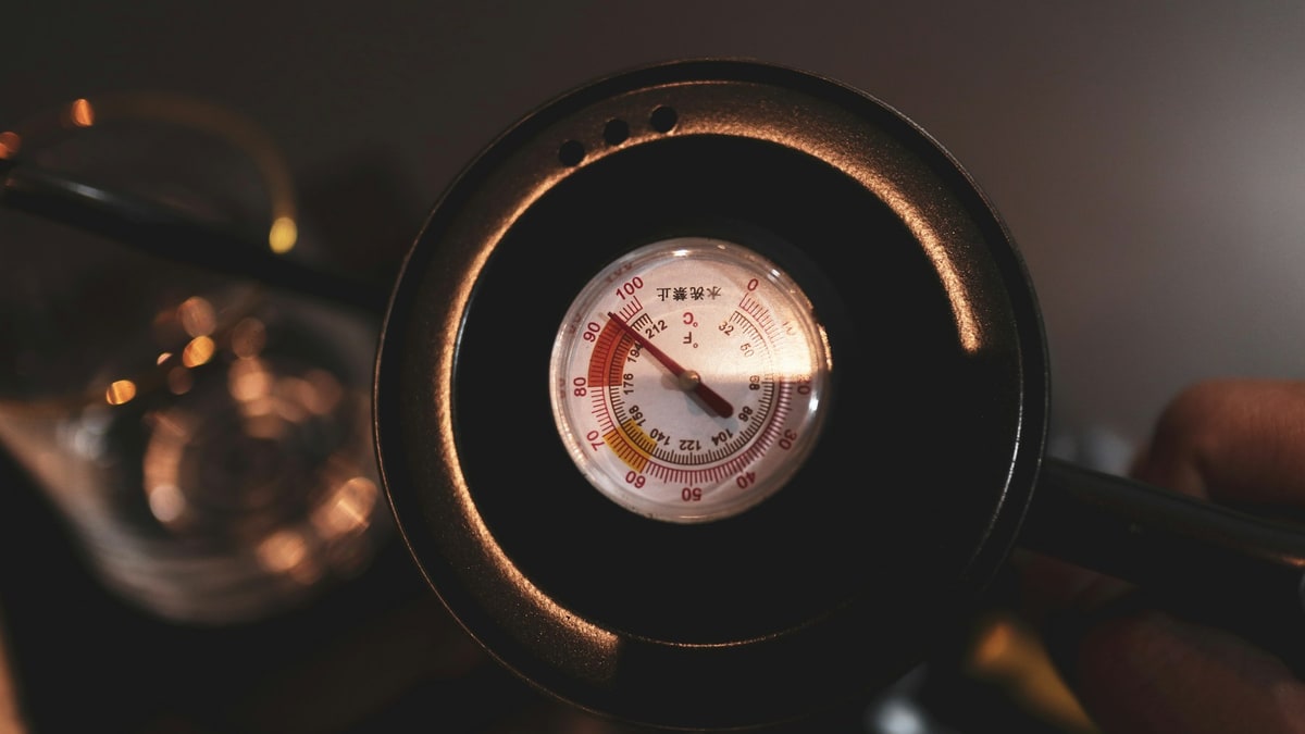 Hand reading a pressure gauge close up.