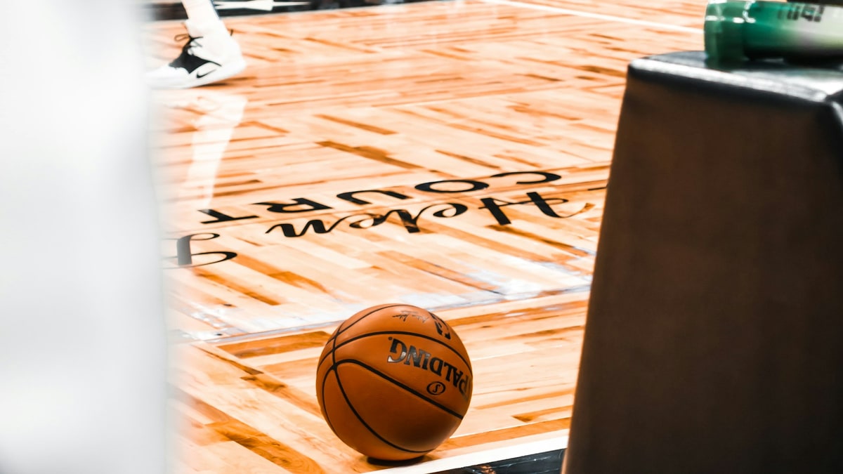Basketball on a hardwood court before practice.