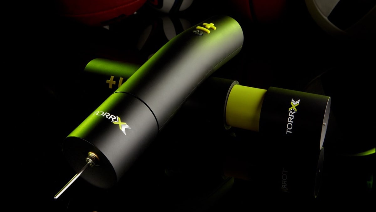 TorrX smart ball pump staged with team sports balls.
