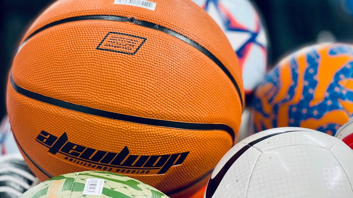Organized sports equipment storage with balls ready for teams.