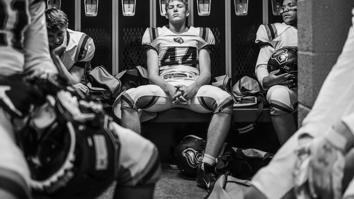 Football equipment in a locker-room setting.