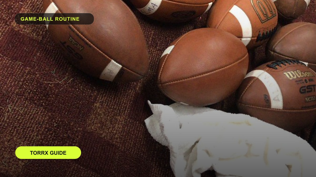 Footballs and a towel laid out on the floor before a pressure check.