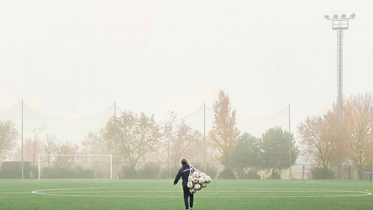 Portable soccer equipment bag on a field sideline.