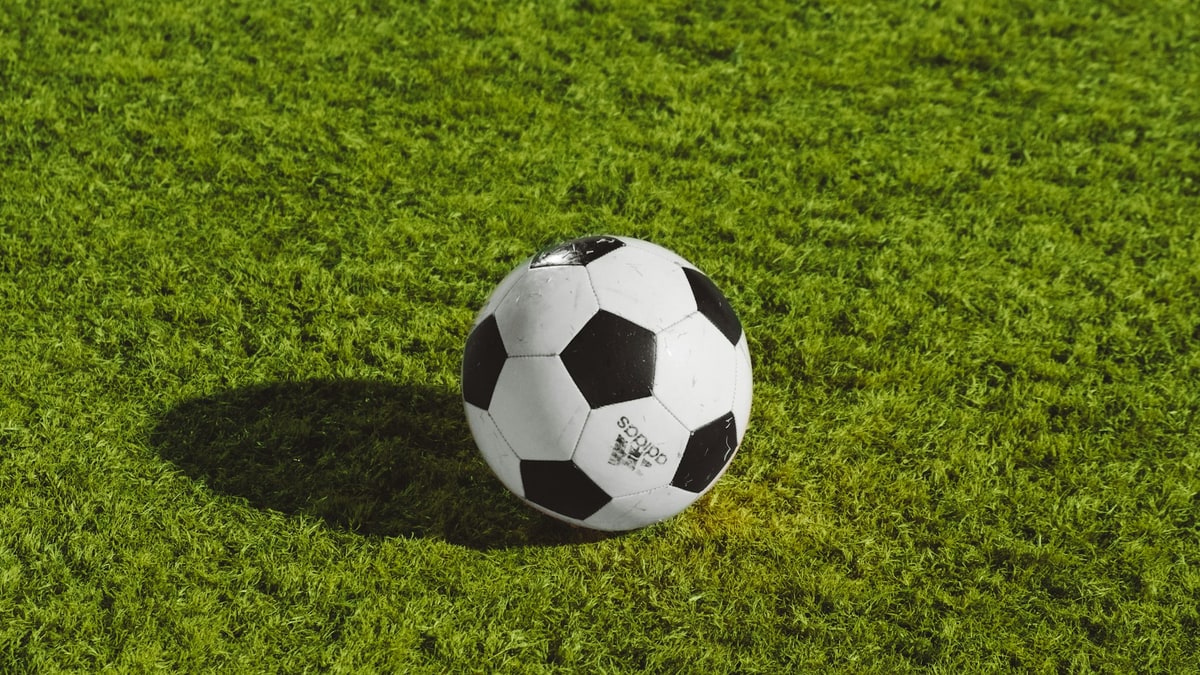 Soccer ball on a turf field before play.