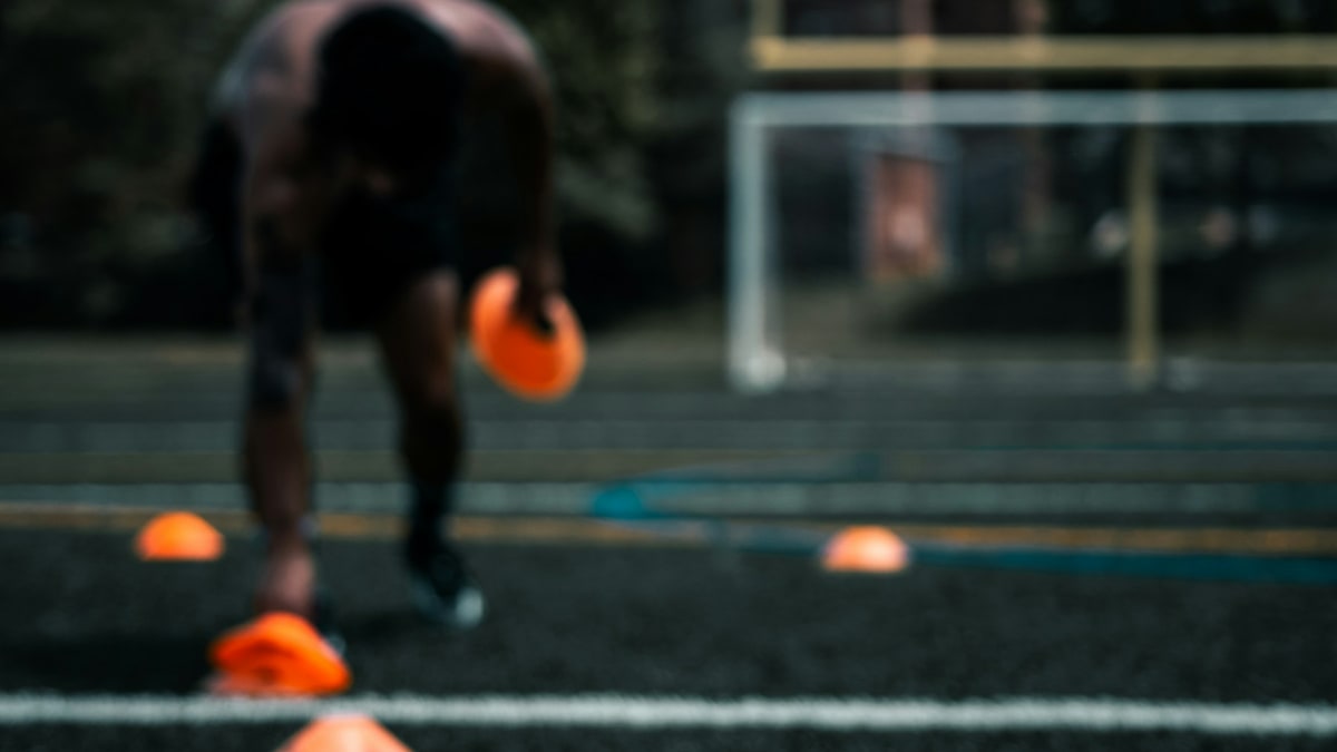 Soccer balls and training cones ready for practice.