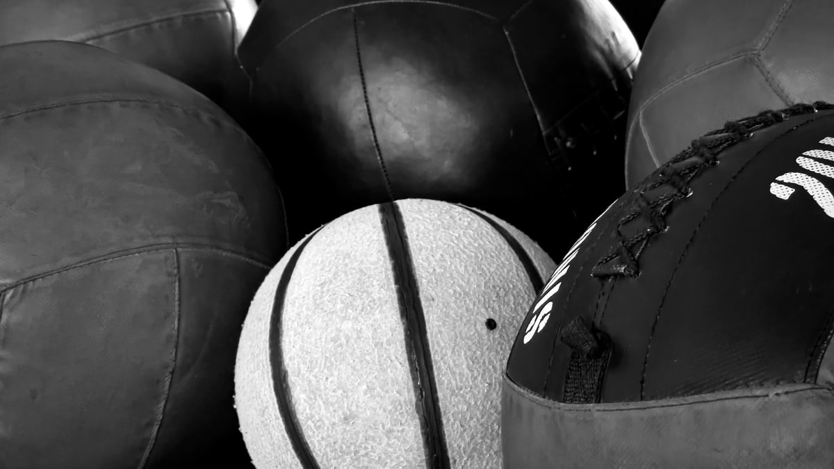 Mixed sports balls gathered for team equipment prep.