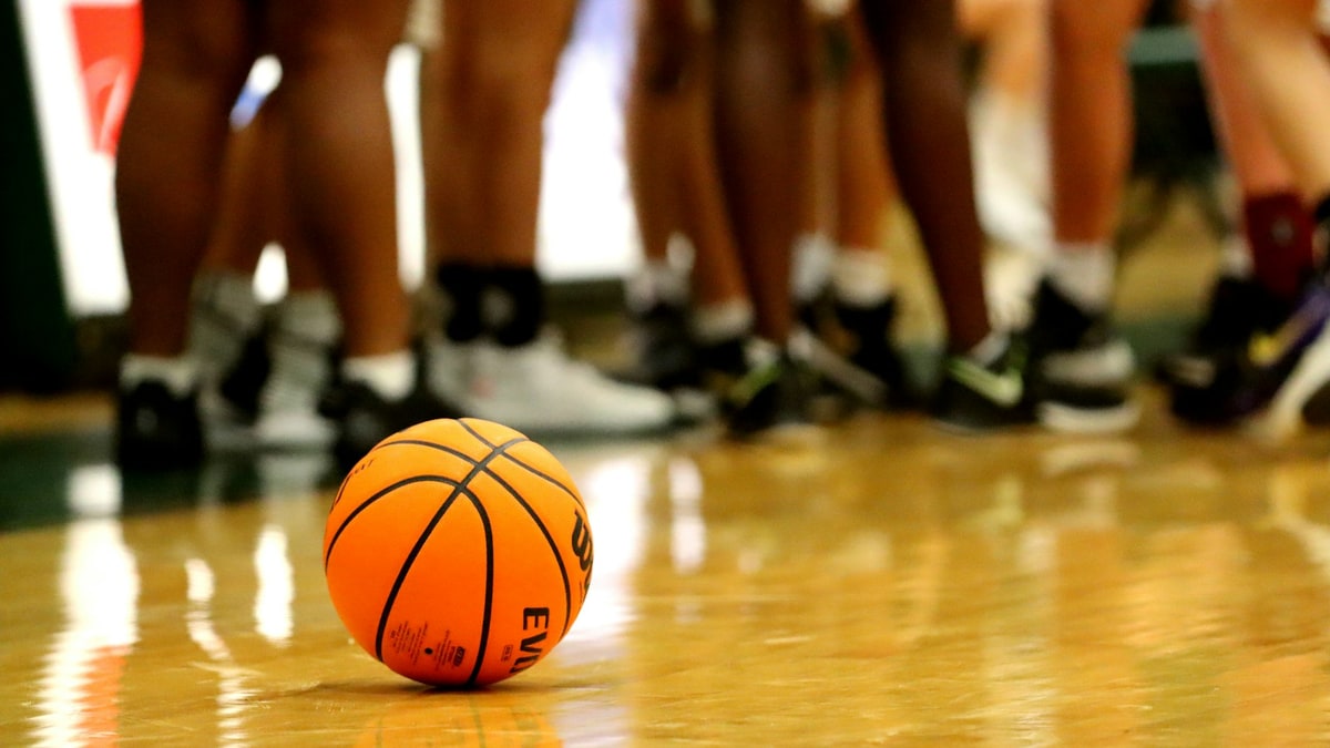 Basketballs on a court sideline for equipment comparison.